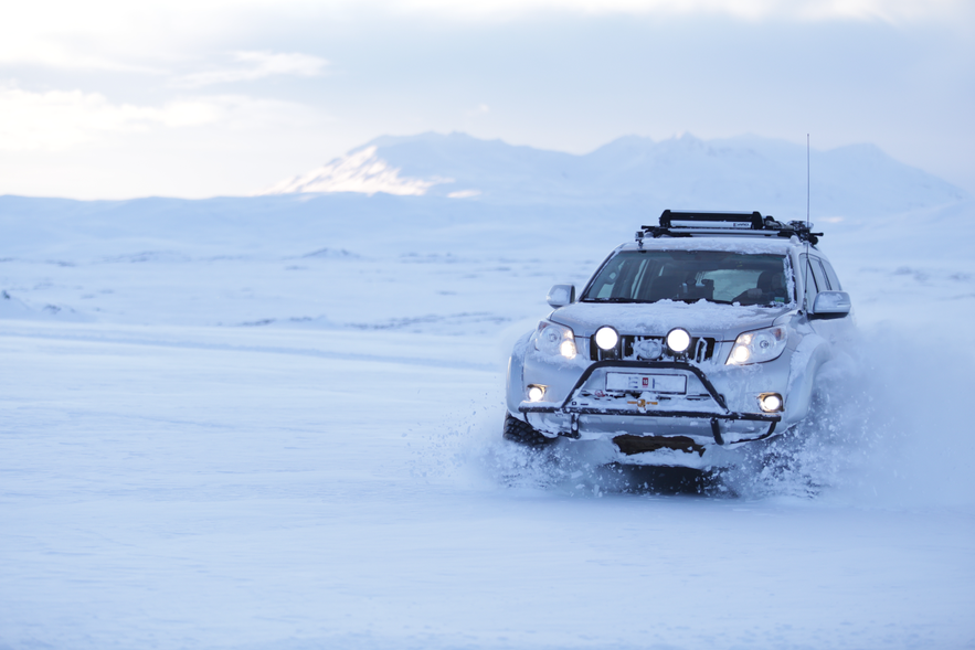Jeep or SUV driving in snow in Iceland Jeep or SUV driving in snow in Iceland