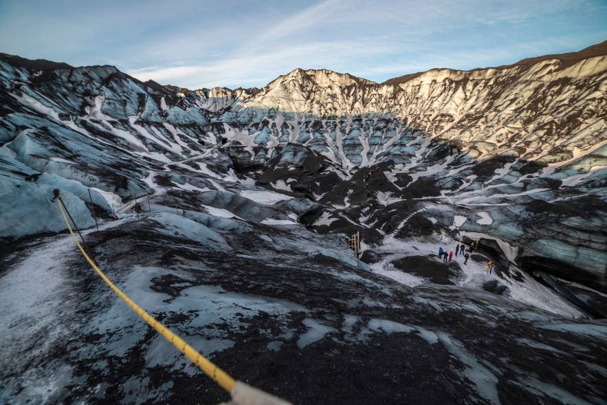 Marked guided route across the ash-streaked ice of Myrdalsjokull Glacier above Katla. Marked guided route across the ash-streaked ice of Myrdalsjokull Glacier above Katla.
