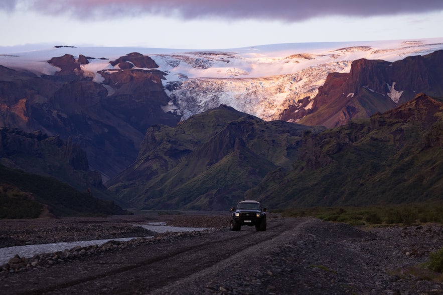 A 4x4 vehicle driving on a gravel road in the South Coast of Iceland.