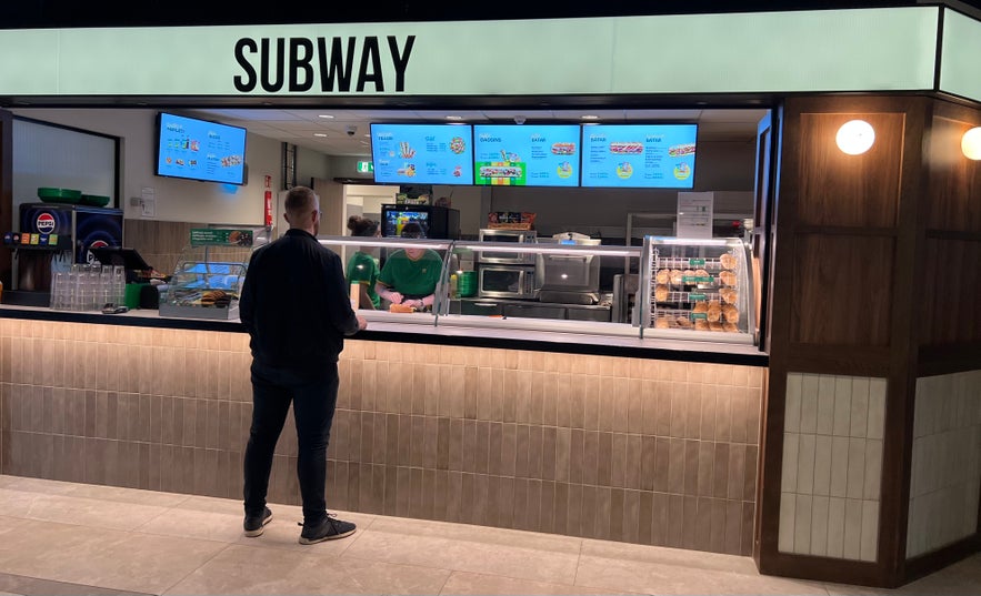 Man buying subway sandwich in Reykjavik Iceland