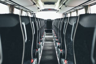 The interior of a bus seen empty.