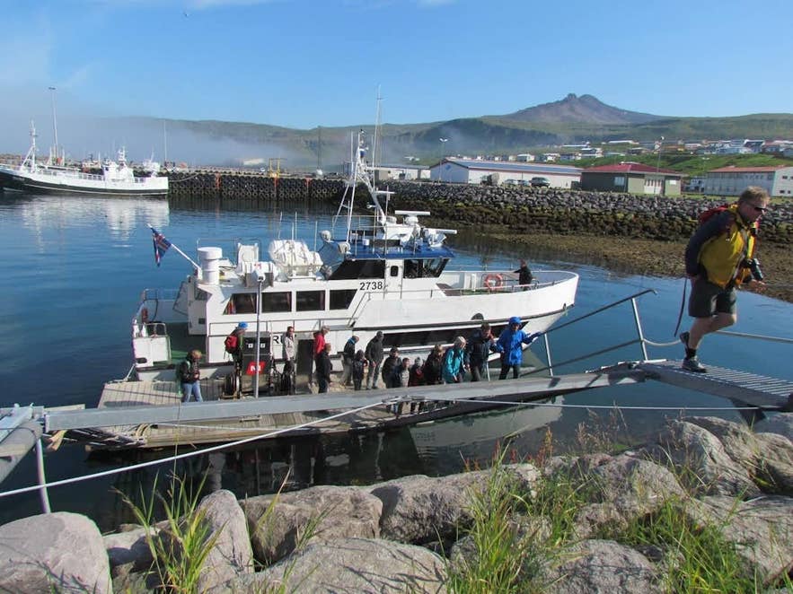 Passengers boarding a whale-watching boat at a Snaefellsnes harbor on a clear day Passengers boarding a whale-watching boat at a Snaefellsnes harbor on a clear day