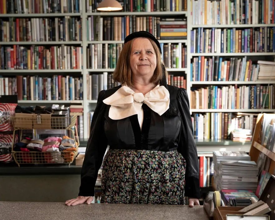 Woman in Icelandic traditional outfit standing in the old bookstore