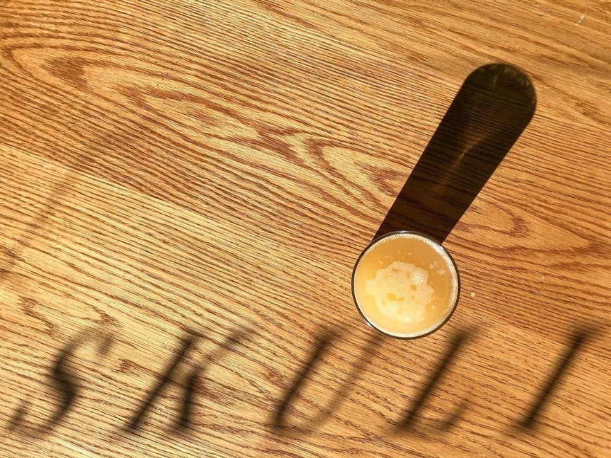 Beer on a table and reflection of the name skuli