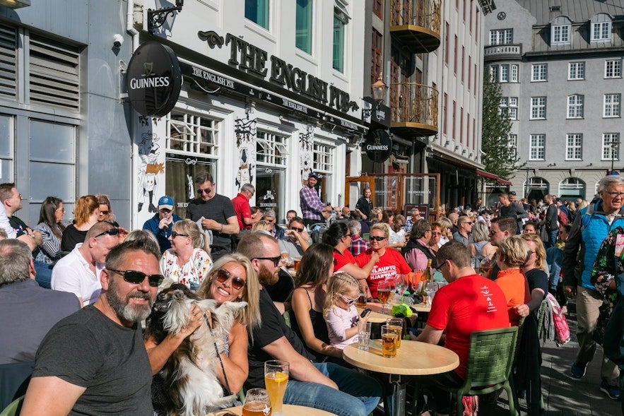 People outside english pub on a sunny day in Reykjavik