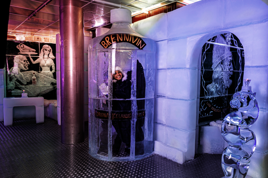 Woman standing in Ice room at magic Ice bar Iceland