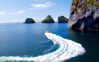 Guests take a boat ride toward one of the many attractions in the Westman Islands.
