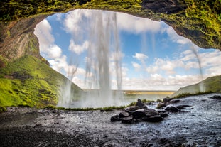 A breathtaking view from behind Seljalandfoss waterfall's water curtain.