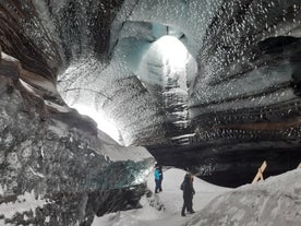 People are seen exploring the inside of Katla glacier ice cave.