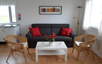 Sofa with a coffee table and two chairs in front of it.