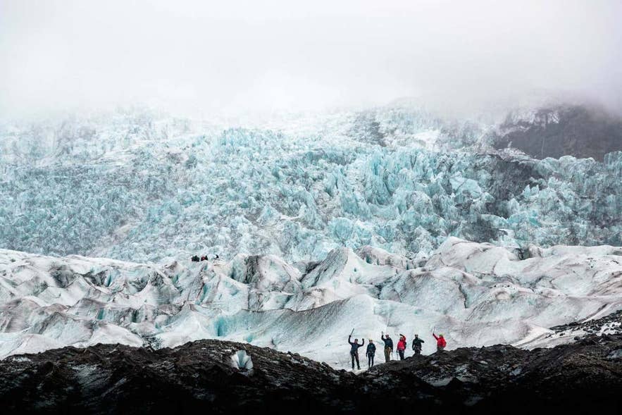 Hikers exploring a vast glacier, showcasing glacier hiking as a thrilling activity in Iceland in February