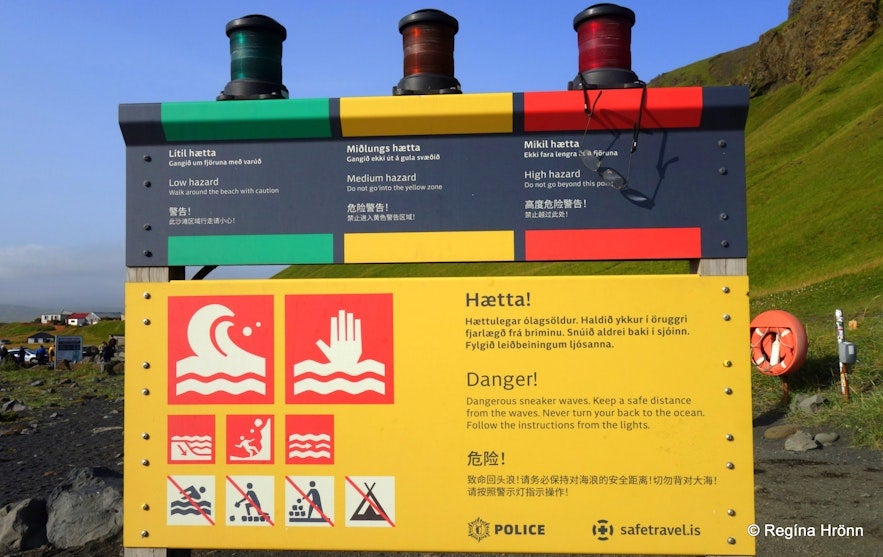 Coastal hazard warning sign at Reynisfjara Black Sand Beach, explaining safety rules and risk levels for how to travel in Iceland.