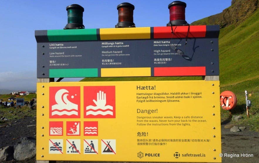 Warning sign at Reynisfjara Black Sand Beach cautioning visitors about dangerous waves