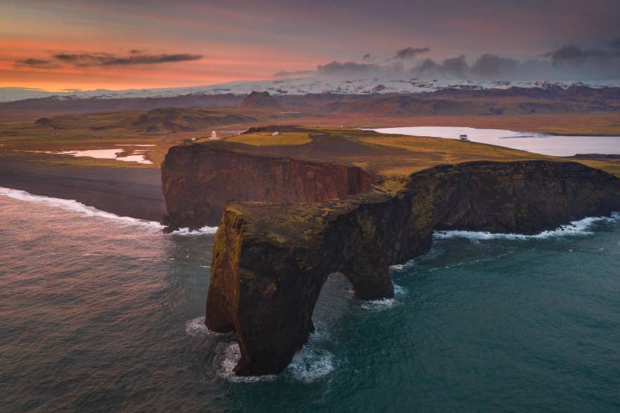 Dyrholaey Rock Arch and black sand coastline seen from above in summer