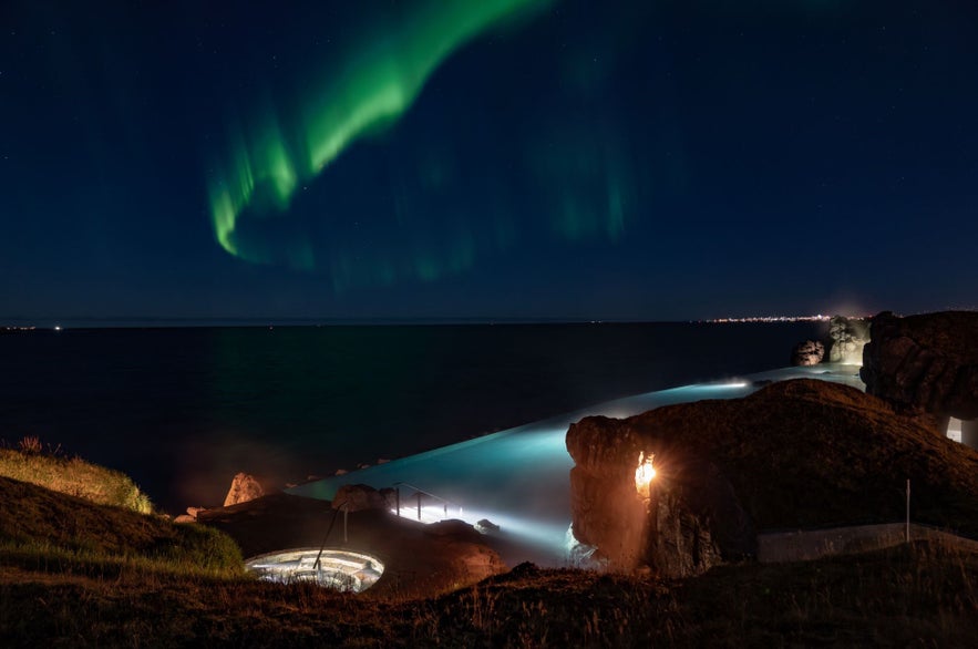 The northern lights dancing over the Sky Lagoon in Reykjavik