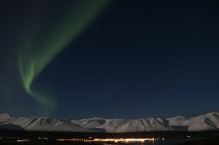 A beautiful mountain in the background compliments the streaking northern lights.