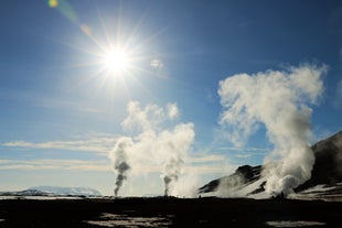 The sun shines in the sky over a geothermal area in North Iceland.