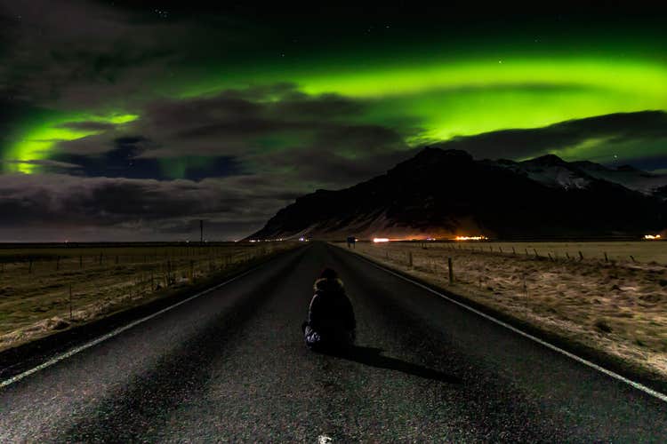 A tour joiner enjoys the aurora borealis near Reykjavik.