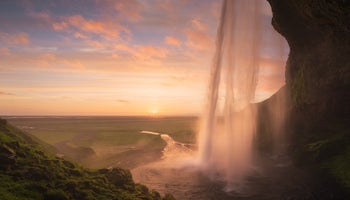 Seljalandsfoss on the South Coast of Iceland bathed in the otherworldly light of the midnight sun.