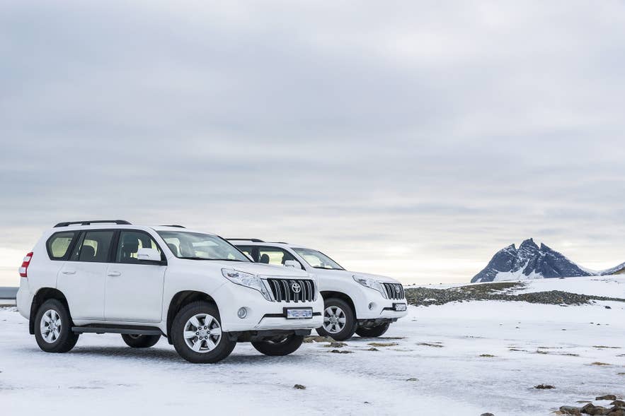 4x4 rental cars parked on snow in Iceland, the right choice for a winter self-drive from December to March.