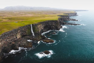 A waterfall empties its water on a beautiful cliffside in Reykjanes peninsula.