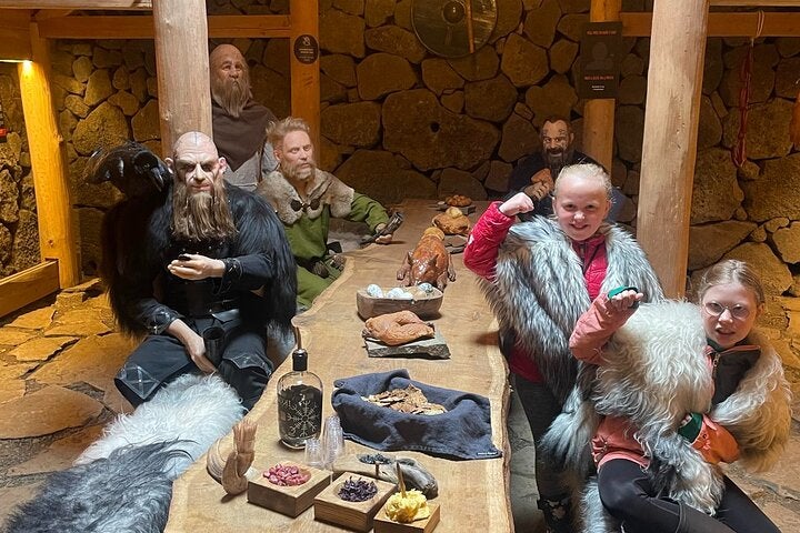 Guests posing with some Vikings at the Herjolfstown Museum.