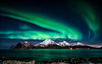 Streams of northern lights twist and curl, illuminating the night with an otherworldly glow.
