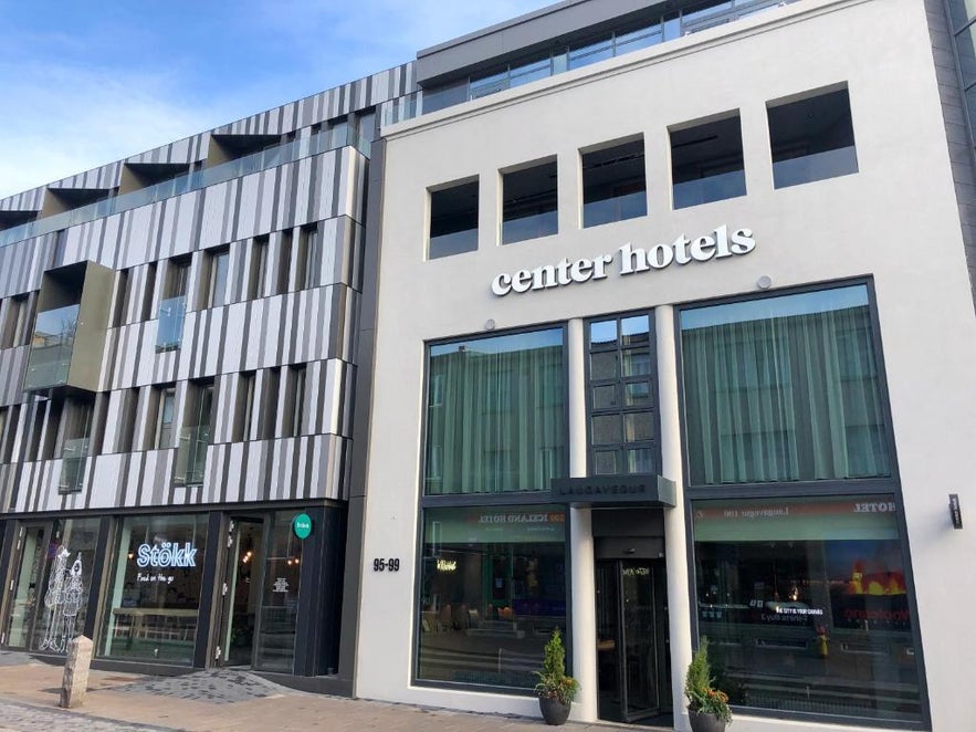Modern exterior of Center Hotels on Laugavegur street in downtown Reykjavik, Iceland, next to a café and shops