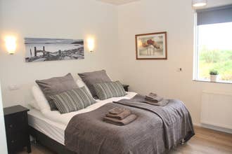 The main bedroom in Lynghagi features a comfortable double bed.