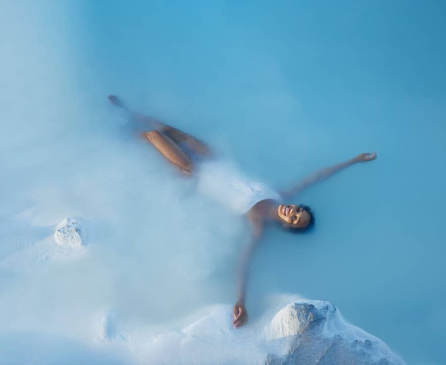 A traveler relaxing in the warm geothermal water of the Blue Lagoon