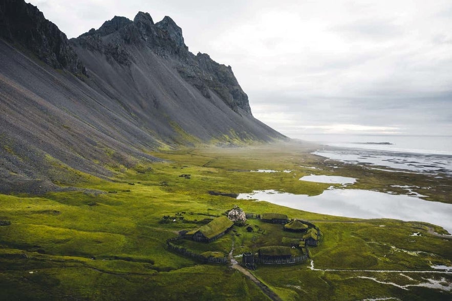 Viking Village film set near Höfn showcasing traditional turf houses and scenery.