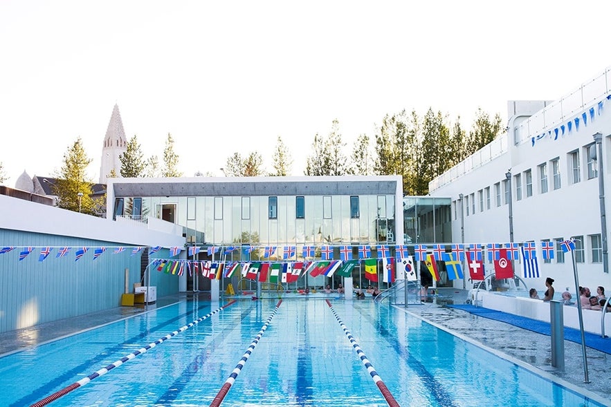 Sundhollin Swimming Pool in Reykjavik with lane flags and hot tubs, a top choice for outdoor swimming pools in Reykjavik city center.