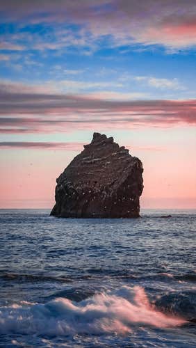Admire the striking Karlinn rock, a solitary sea stack standing in the Reykjanes peninsula.