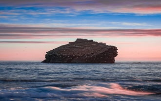 Admire the striking Karlinn rock, a solitary sea stack standing in the Reykjanes peninsula.