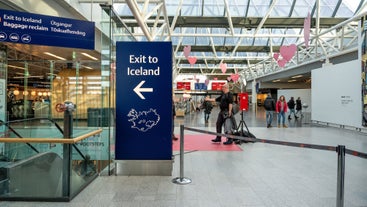 The arrivals hall at Keflavik International Airport with an 'Exit to Iceland' sign.