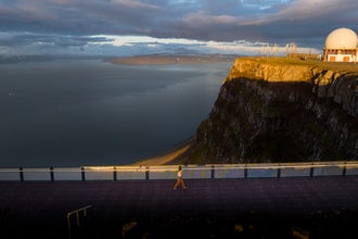 A guest walks along the viewing platform on Mount Bolafjall.