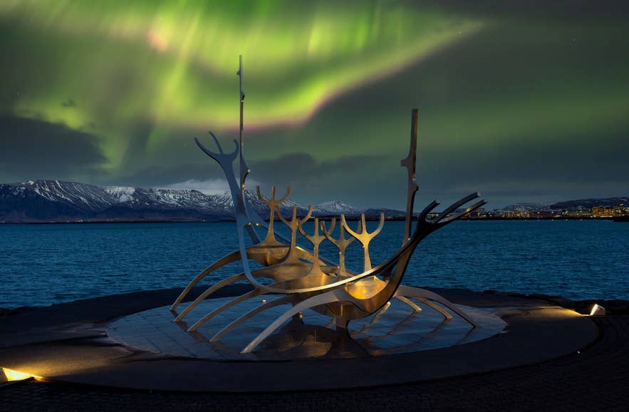 L’aurora boreale danza sopra la scultura del Viaggiatore del Sole a Reykjavík.
