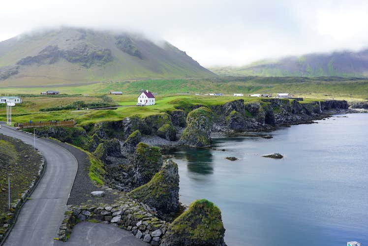 The Snaefellsnes peninsula's Arnarstapi village boasts a scenic cliffside.
