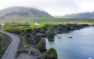 The Snaefellsnes peninsula's Arnarstapi village boasts a scenic cliffside.
