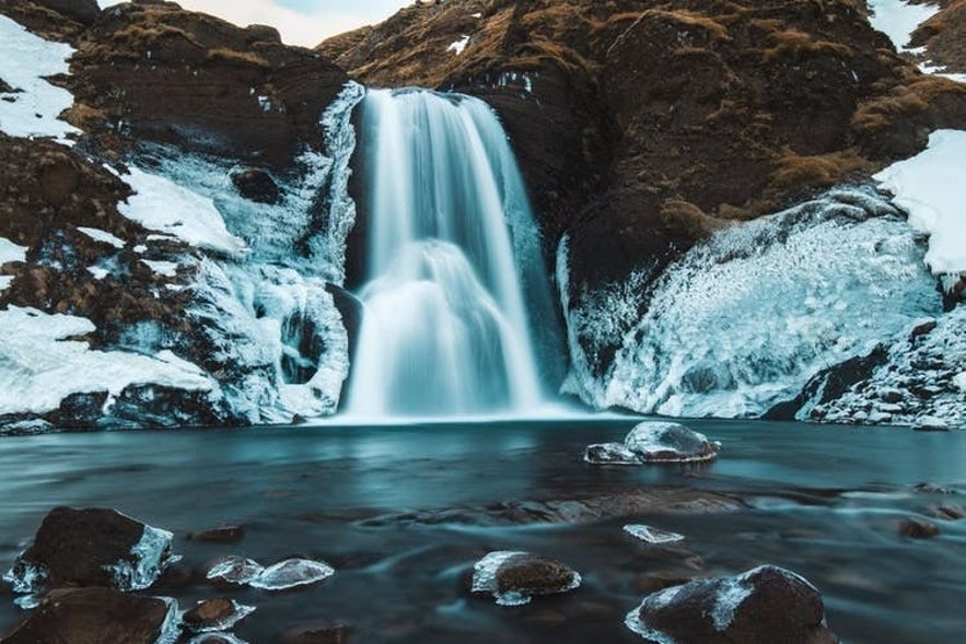 Helgufoss waterfall is located near the Golden Circle route.