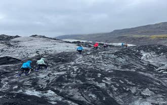 A group of hikers ascend the glacier of Solheimajokull during a guided hike.