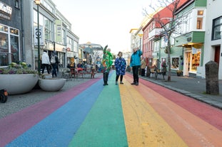 A guide with a small group tour on the rainbow road in Reykjavik.