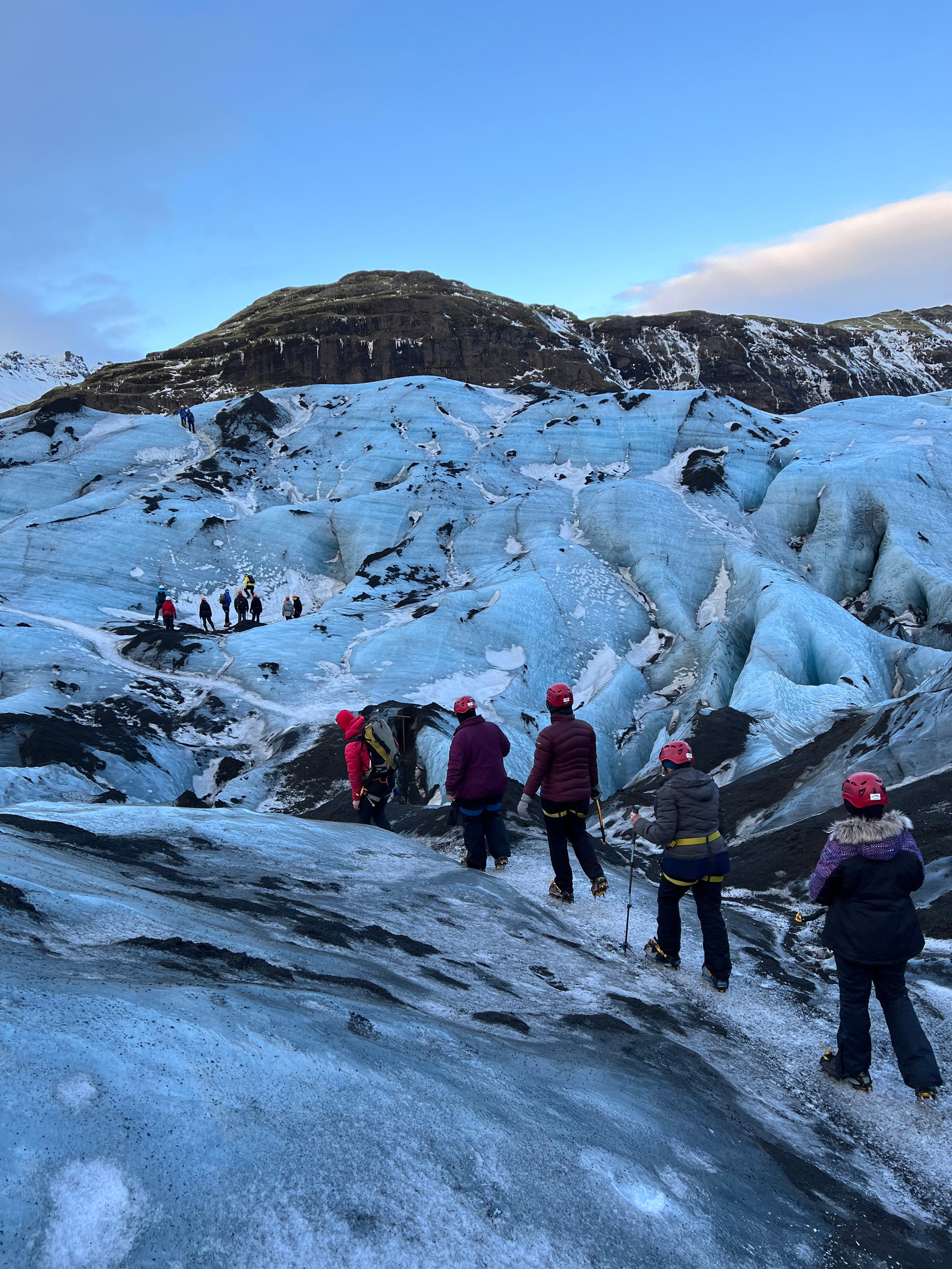 A group of female travelers begin their hike on snowy trails.