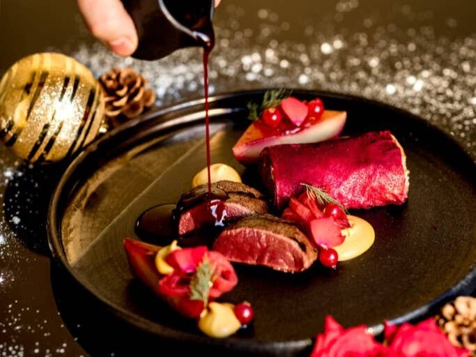 Gourmet holiday dinner at Kol restaurant in Reykjavik with seared meat, root vegetables, and sauce