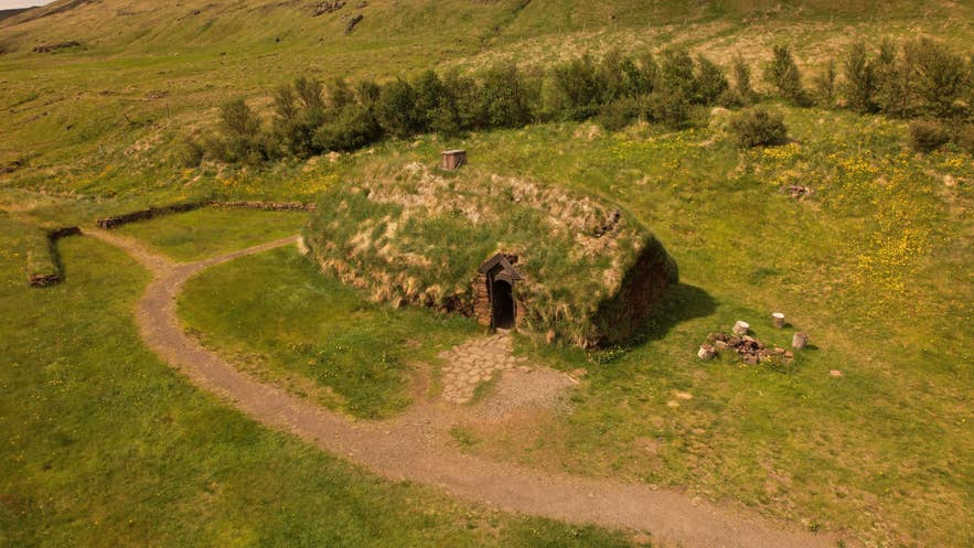 Turf-covered Viking-age longhouse at Eiriksstadir in a grassy valley