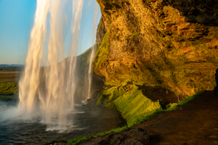 Seljalandsfoss waterfall allows visitors to walk behind its water curtain.