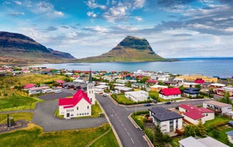 The iconic Kirkjufell mountain towers above the village of Grundarfjordur in Snaefellsnes.