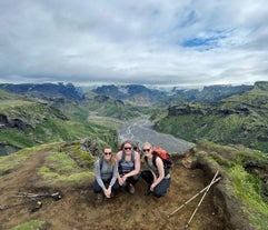 A trio of women hikers posing for a photo while atop a mountain in Thorsmork.