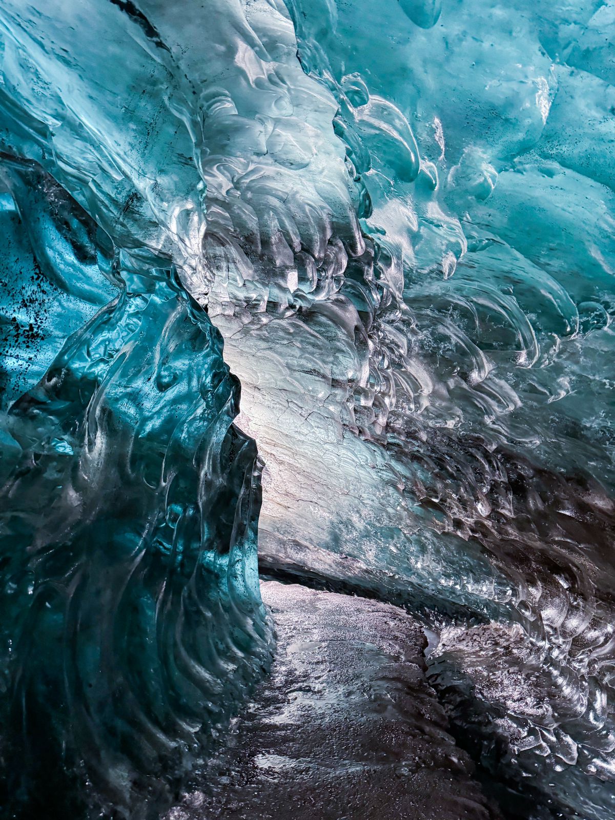 The crystal clear blue colors of an ice cave can be seen in Vatnajokull glacier.