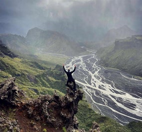 A hiker celebrates with a photo atop a mountain in Thorsmork.